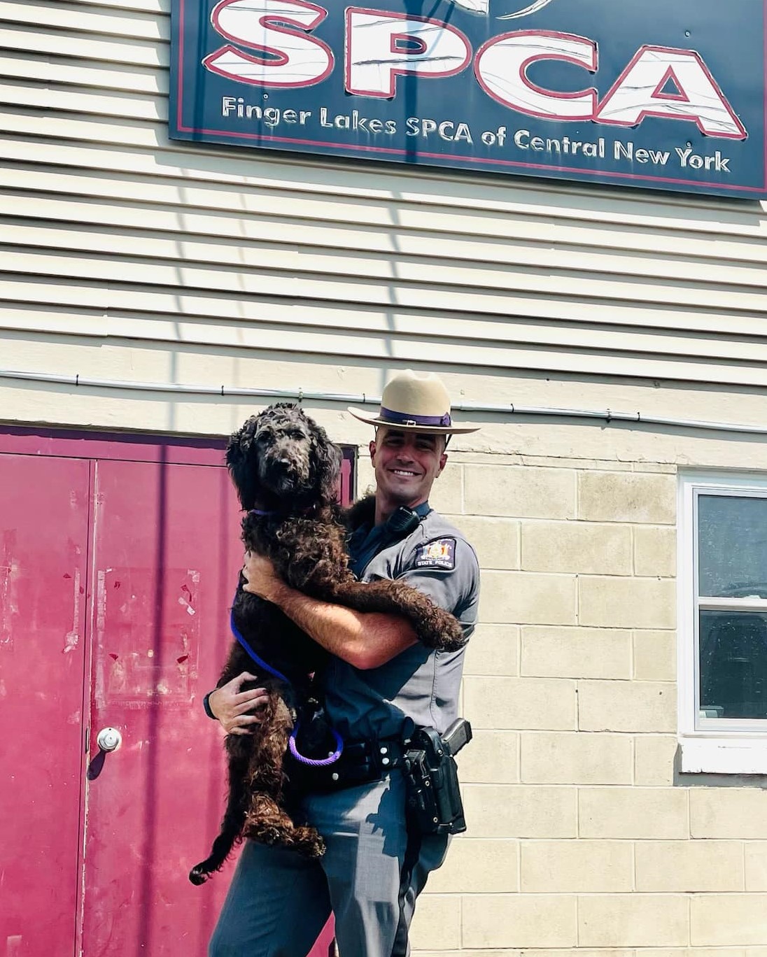 Good news: NY State Police officer gets big hug after rescuing dog from ...